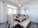 Bright dining room with a table set for six at 11021 Ogden Ln, Charlotte, NC 28278