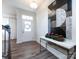 Bright foyer with hardwood floors, a decorative console table, and a staircase at 11021 Ogden Ln, Charlotte, NC 28278