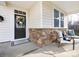 Inviting front porch with stone accents and comfortable seating area at 11021 Ogden Ln, Charlotte, NC 28278