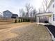 Side view of a two-story house with covered patio, and a grassy backyard at 11021 Ogden Ln, Charlotte, NC 28278