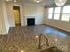 Living room with fireplace and kitchen island view at 11021 Ogden Ln, Charlotte, NC 28278