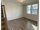 Simple spare bedroom with hardwood floors and neutral wall colors at 11021 Ogden Ln, Charlotte, NC 28278