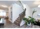 Elegant staircase with wrought-iron railing and neutral carpeting at 11021 Ogden Ln, Charlotte, NC 28278