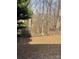 Large backyard surrounded by mature trees and a wooden fence at 11124 Northwoods Forest Dr, Charlotte, NC 28214