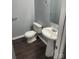 Compact half bathroom with a pedestal sink and modern fixtures at 11124 Northwoods Forest Dr, Charlotte, NC 28214