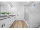 Bright bathroom featuring a walk-in glass shower, double vanity with quartz counters, and modern fixtures at 113 Brentwood Dr, Maiden, NC 28650