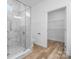 Elegant bathroom with a tiled shower, a glass door, and a view into the walk-in closet at 113 Brentwood Dr, Maiden, NC 28650