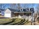 New home exterior featuring gray siding, stone accents, and covered porch at 113 Brentwood Dr, Maiden, NC 28650