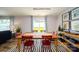 Bright dining room featuring a spacious table with red chairs and access to backyard at 12152 Lady Bell Dr, Charlotte, NC 28278