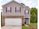 Two-story house with brick and siding, a white garage door, and landscaping at 12152 Lady Bell Dr, Charlotte, NC 28278