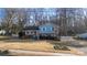 Bird's eye view of a charming ranch home with a spacious yard and surrounding trees at 1224 Castlegate St, Gastonia, NC 28054