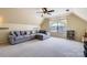 Spacious bonus room with vaulted ceiling, ceiling fan, and plush carpeting at 12338 Shadow Ridge Ln, Charlotte, NC 28273