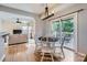 Bright dining area with wood floors, modern chandelier, and access to a deck, open to living room at 12338 Shadow Ridge Ln, Charlotte, NC 28273