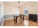 Dining room with hardwood floors, chandelier, and neutral paint at 12338 Shadow Ridge Ln, Charlotte, NC 28273