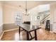 Dining room with hardwood floors, chandelier, and staircase at 12338 Shadow Ridge Ln, Charlotte, NC 28273