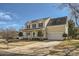 Inviting two-story home with covered front porch, attached two-car garage, and mature landscaping at 12338 Shadow Ridge Ln, Charlotte, NC 28273