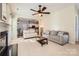 Cozy living room features neutral tones, a ceiling fan, and access to the kitchen, creating a welcoming atmosphere at 12338 Shadow Ridge Ln, Charlotte, NC 28273