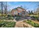 Brick house with a large backyard and stone pathway at 12710 Winding Ridge Rd, Huntersville, NC 28078