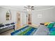 Bright bedroom with daybed, colorful rug, and access to bathroom at 12710 Winding Ridge Rd, Huntersville, NC 28078