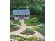 Landscaped backyard with a stone pathway and shed at 12710 Winding Ridge Rd, Huntersville, NC 28078