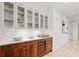 Built-in bar with glass-front cabinets and hexagon tile backsplash at 130 Cherokee Rd # 403, Charlotte, NC 28207