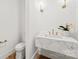 Stylish powder room with marble floating vanity and gold fixtures at 130 Cherokee Rd # 403, Charlotte, NC 28207