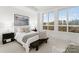 Bright bedroom with a queen bed and large windows at 130 Cherokee Rd # 403, Charlotte, NC 28207