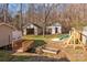 Playset, sheds, and bridge in backyard at 1325 Bostwood Ln, Concord, NC 28025