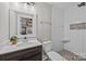 Modern bathroom with herringbone tile shower and dark vanity at 1325 Bostwood Ln, Concord, NC 28025