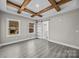 Spacious bedroom with wood beams, sliding barn door, and wood floors at 1325 Bostwood Ln, Concord, NC 28025