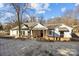 White house with brick base and paved driveway at 1325 Bostwood Ln, Concord, NC 28025