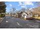 Brick and white home with paved driveway at 1325 Bostwood Ln, Concord, NC 28025