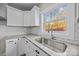 Kitchen corner sink with granite countertops and white cabinets at 1325 Bostwood Ln, Concord, NC 28025