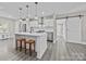 Modern kitchen with white shaker cabinets, island, and stainless steel appliances at 1325 Bostwood Ln, Concord, NC 28025