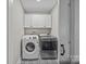 Laundry room with washer, dryer, and white cabinets at 1325 Bostwood Ln, Concord, NC 28025