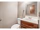 Small bathroom with a vanity, toilet and mirror at 14264 Maple Hollow Ln, Mint Hill, NC 28227