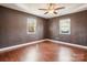 Cozy bedroom with wood floors and two windows at 14264 Maple Hollow Ln, Mint Hill, NC 28227