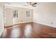 Bright bedroom featuring wood floors and large windows at 14264 Maple Hollow Ln, Mint Hill, NC 28227