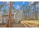 Gray house exterior with detached workshop and wooded lot at 14264 Maple Hollow Ln, Mint Hill, NC 28227