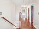 Upstairs hallway with hardwood floors and access to bedrooms and bathroom at 14264 Maple Hollow Ln, Mint Hill, NC 28227