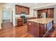 Kitchen with island, stainless steel appliances, and hardwood floors at 14264 Maple Hollow Ln, Mint Hill, NC 28227