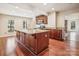 Kitchen island with granite countertop and wood cabinets at 14264 Maple Hollow Ln, Mint Hill, NC 28227