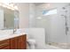 Clean bathroom with a walk-in shower, single vanity, and white tile at 14310 Cameryn Elise Dr, Cornelius, NC 28031