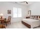 Spacious bedroom with wooden furniture, a desk, and window shutters at 14310 Cameryn Elise Dr, Cornelius, NC 28031