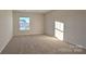 Bright bedroom with carpet and large window at 14509 Winged Teal Rd, Charlotte, NC 28278