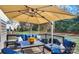 Relaxing deck with patio furniture, umbrella, and built-in grill at 15903 Glen Miro Dr, Huntersville, NC 28078