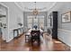 Bright dining room with hardwood floors, a large table, and a built-in hutch at 15903 Glen Miro Dr, Huntersville, NC 28078