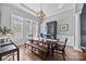 Elegant dining room with hardwood floors, a large table, and a built-in hutch at 15903 Glen Miro Dr, Huntersville, NC 28078