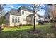 Two-story home's back exterior, featuring a sunroom and landscaped yard at 15903 Glen Miro Dr, Huntersville, NC 28078