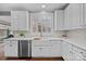 Modern kitchen with white cabinets and farmhouse sink at 15903 Glen Miro Dr, Huntersville, NC 28078